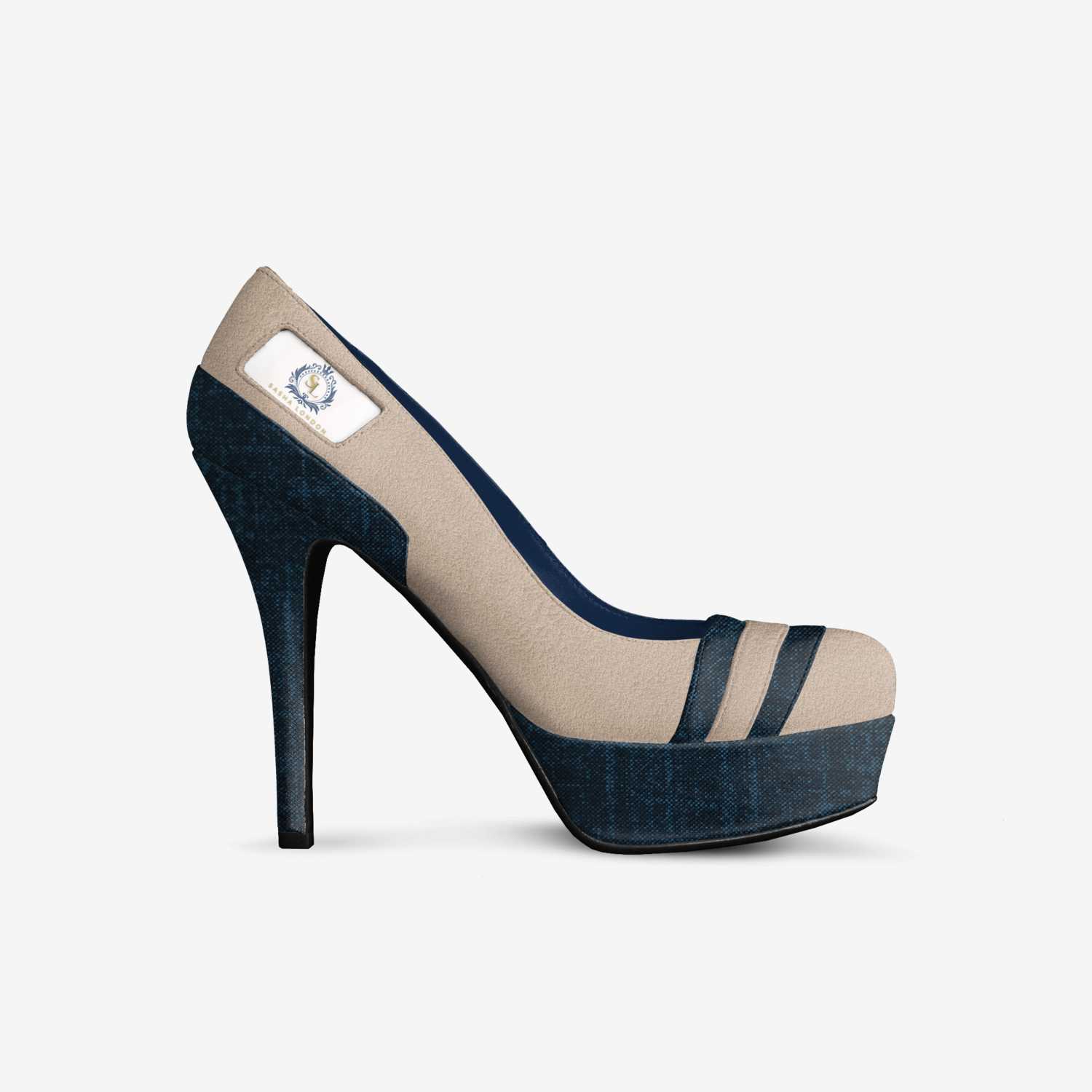 Elegant high-heel shoe with navy suede and beige accents, featuring a sleek platform and a decorative embellishment, showcased on a white background.