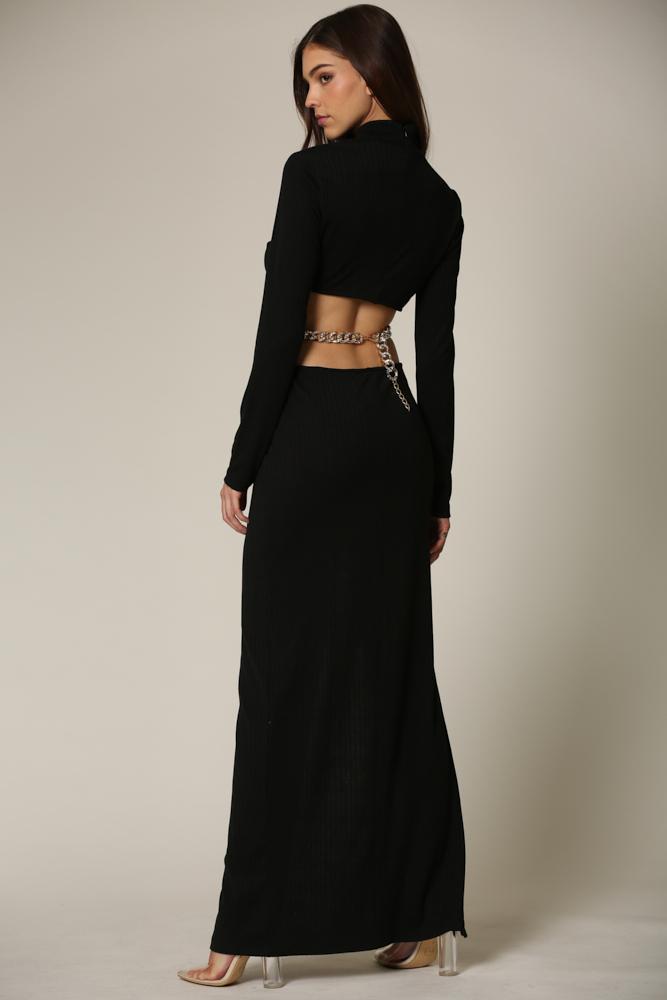 Sophisticated black maxi dress featuring high-neck and open back design, styled with metallic accessories for a modern, chic look.