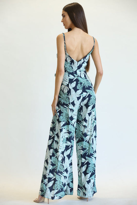 Elegant leaf/palm print jumpsuit with adjustable spaghetti straps, cinched waist, and wide leg design for a stylish and comfortable look.