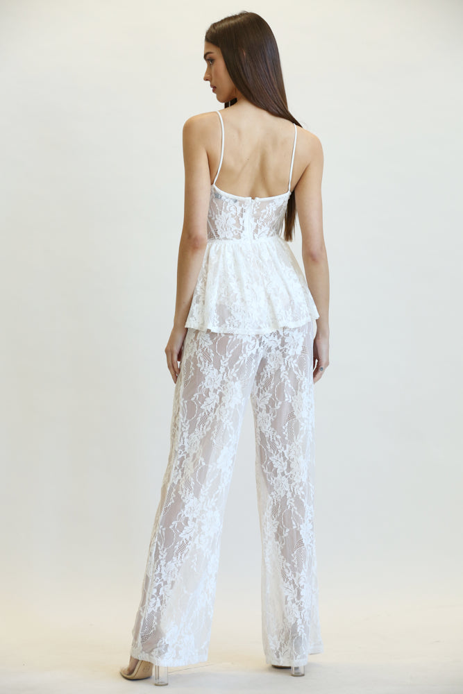 Elegant white lace jumpsuit with peplum waist, featured against plain background