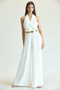 Elegant white pleated jumpsuit with gold button details, styled on a woman against a plain background.