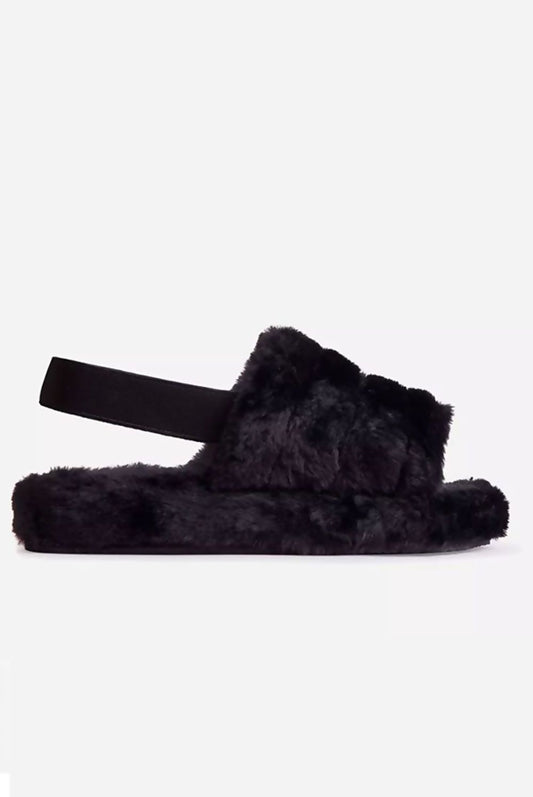 Plush black faux fur slippers with a velcro strap for cozy comfort.