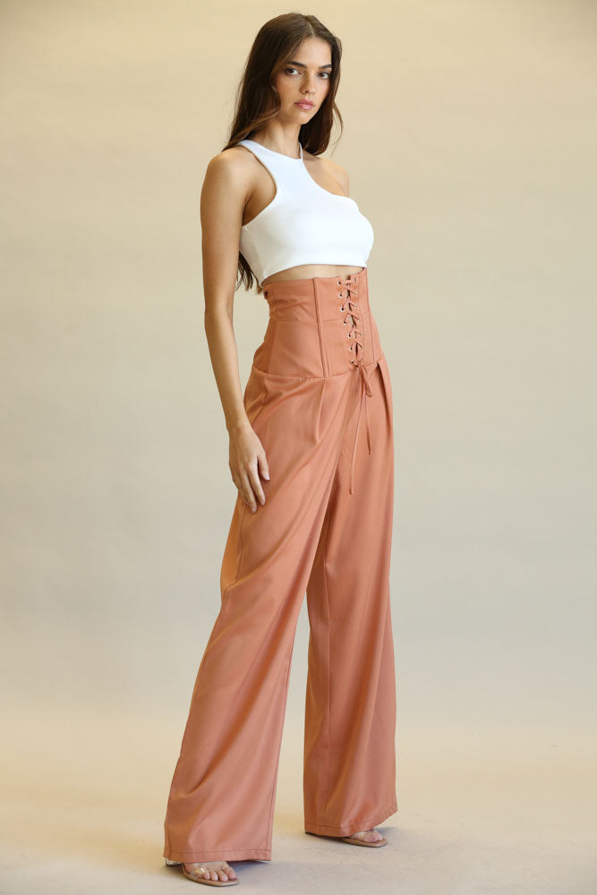 Gala - Ultra High Waist Salmon Pants
Chic high-waisted salmon pants with lace-up design, showcased on a young female model in a white outfit.