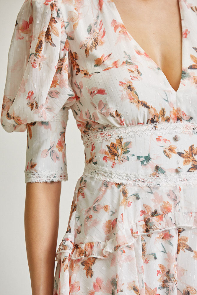 Delicate floral printed romper with ruffled details and puffed sleeves, showcasing a stylish and feminine design from White Amphitryon for the LoveAdora fashion collection.