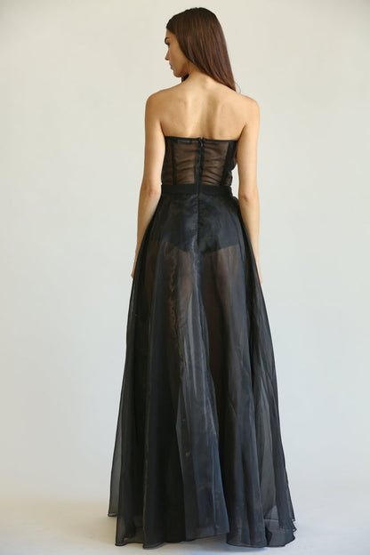 Elegant black evening gown with a strapless bodice and a flowing tulle skirt, creating a sophisticated and glamorous look for formal occasions.