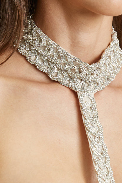 Sparkly rhinestone necklace on woman's bare shoulders