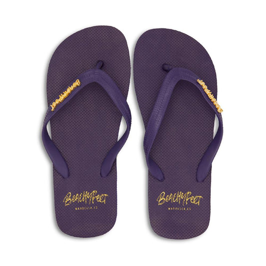 Plush purple BeachyFeet® Azul Marino sandals with gold logo details, against a white background.