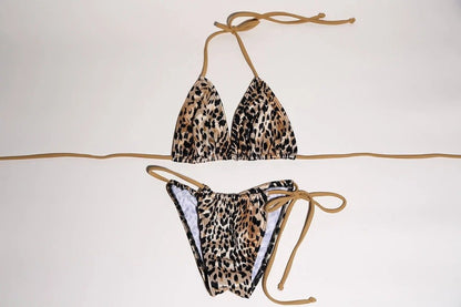 Chic leopard print bikini set, featuring halter-style top and low-rise bottoms with tie sides, for a stylish beachwear look.