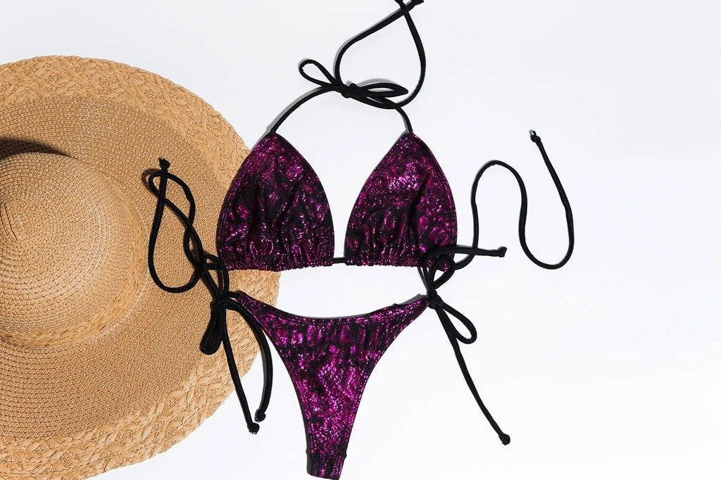 Purple sequined bikini and straw hat