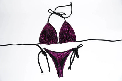 Vibrant purple paisley bikini top and bottom set by White Amphitryon, featuring intricately patterned fabric, tie-side bottoms, and a halter-style top for a stylish beachwear look.