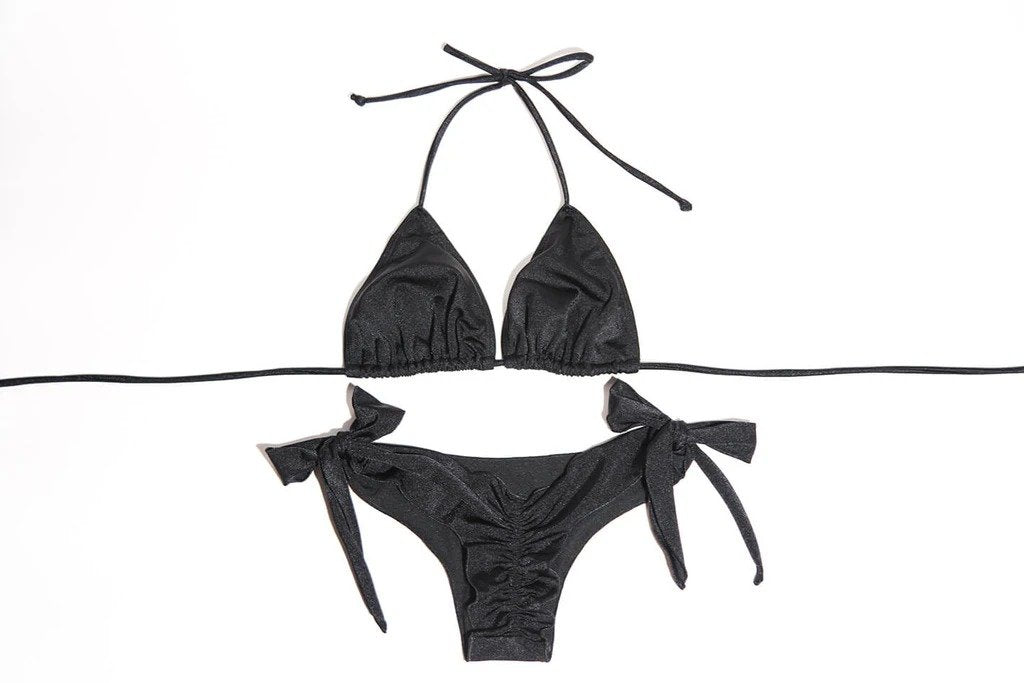 Elegant black swimsuit with tie details, featuring a triangle bikini top and matching bottoms with bow accents, displayed on a plain white background.