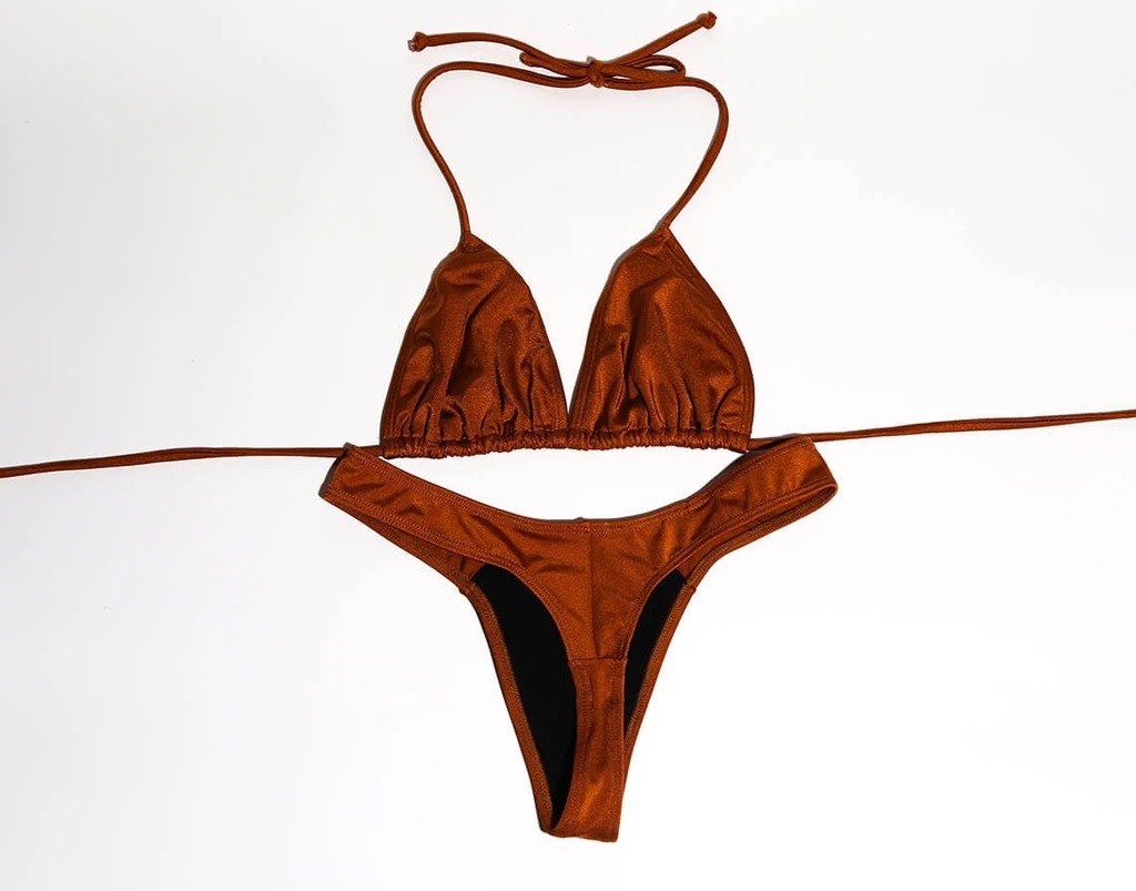 Rust-colored bikini top and bottoms by White Amphitryon displayed against a white background.