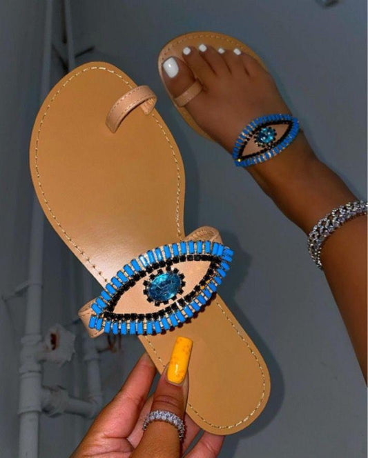 Rhinestone-embellished sandals with bold eye design