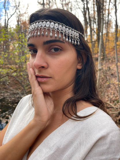 Goddess Warrior Head Chain - Intricate metal and bead headpiece adorning the model's face against a natural, wooded backdrop.