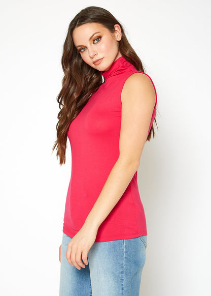 Sleeveless fitted turtleneck top in bold red color, worn by a young woman with long wavy hair posing against a plain white background.