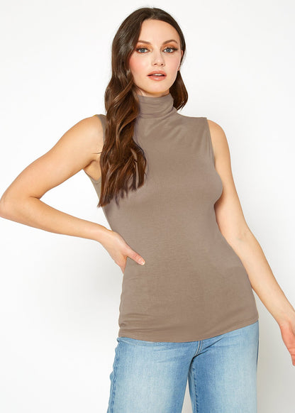 Taupe sleeveless fitted top with turtleneck, worn by a young woman with long wavy hair against a white background.