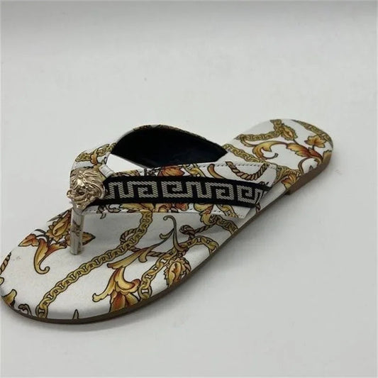 Stylish patterned slippers with intricate gold and black designs