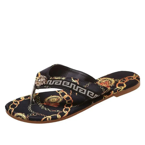 Stylish printed slippers with a bold, chain and ornamental pattern design. The dark-colored, casual footwear features a comfortable, slip-on design for easy wear.