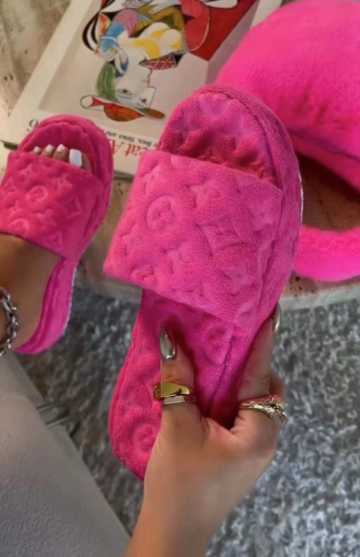 Cozy fuchsia fur slides with floral design, perfect footwear accessory for the modern fashionista.