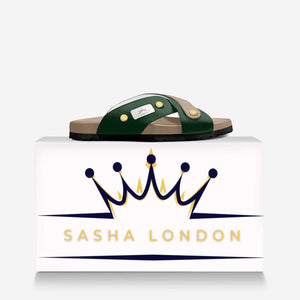 Sasha London Sandal - Stylish women's slide sandals with contrasting green straps and gold-tone metal embellishments, displayed on a minimalist white background with the Sasha London brand logo.