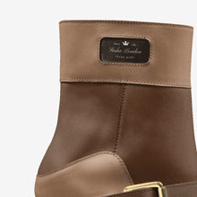 Load image into Gallery viewer, Stylish two-tone leather boot from Sasha London, featuring a sleek, modern design with contrasting colors and a branded leather patch.