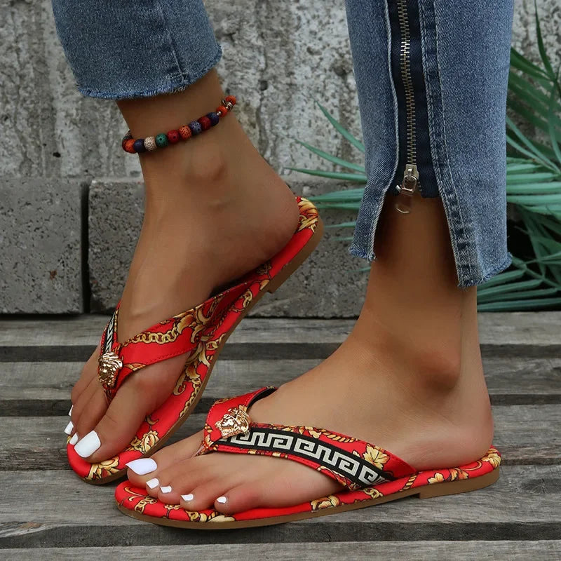 Vibrant bohemian-inspired embroidered sandals with beaded accents, worn with distressed denim for a laid-back, casual style.