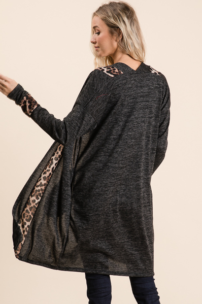 Women's dark gray marled knit pullover with leopard print sleeves and trim, elegant and cozy casual outfit.