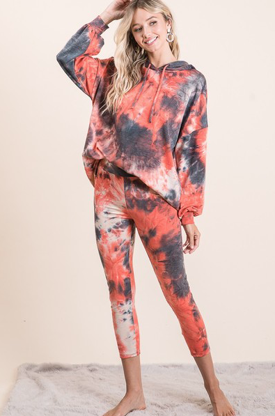 Vibrant tie-dye yoga set with hooded sweatshirt and leggings, designed for active women's fashion.