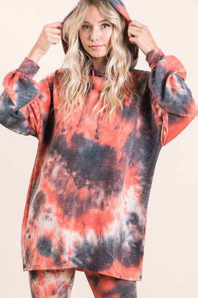 Vibrant tie-dye hooded yoga set with a smiling woman model showcasing the stylish and comfortable design.