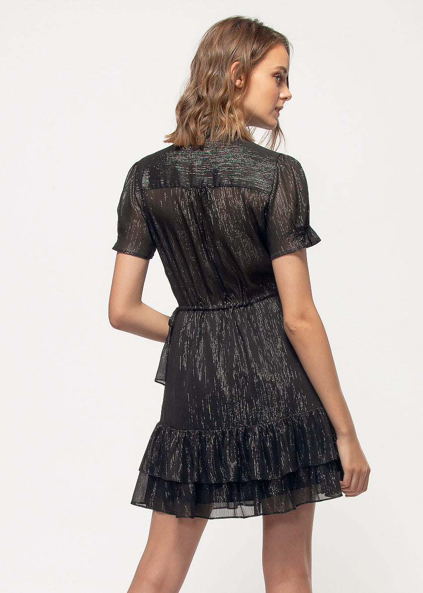 Elegant black metallic dress with ruffle detailing, displayed on a female model wearing the garment.