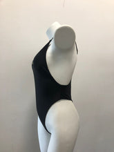 Load image into Gallery viewer, Chic black swimsuit with sleek, minimalist design showcased on a mannequin against a plain background.