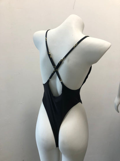 Elegant black swimsuit with criss-cross strap design on a faceless mannequin