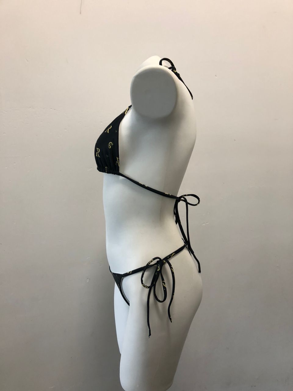 Elegant black lace triangle bikini top on white mannequin body, showcasing a stylish and sophisticated swimwear design.