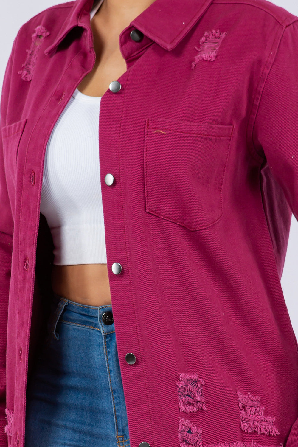 Distressed fuchsia pink denim jacket with button-up front and patch pockets, showcasing a stylish and casual fashion item.