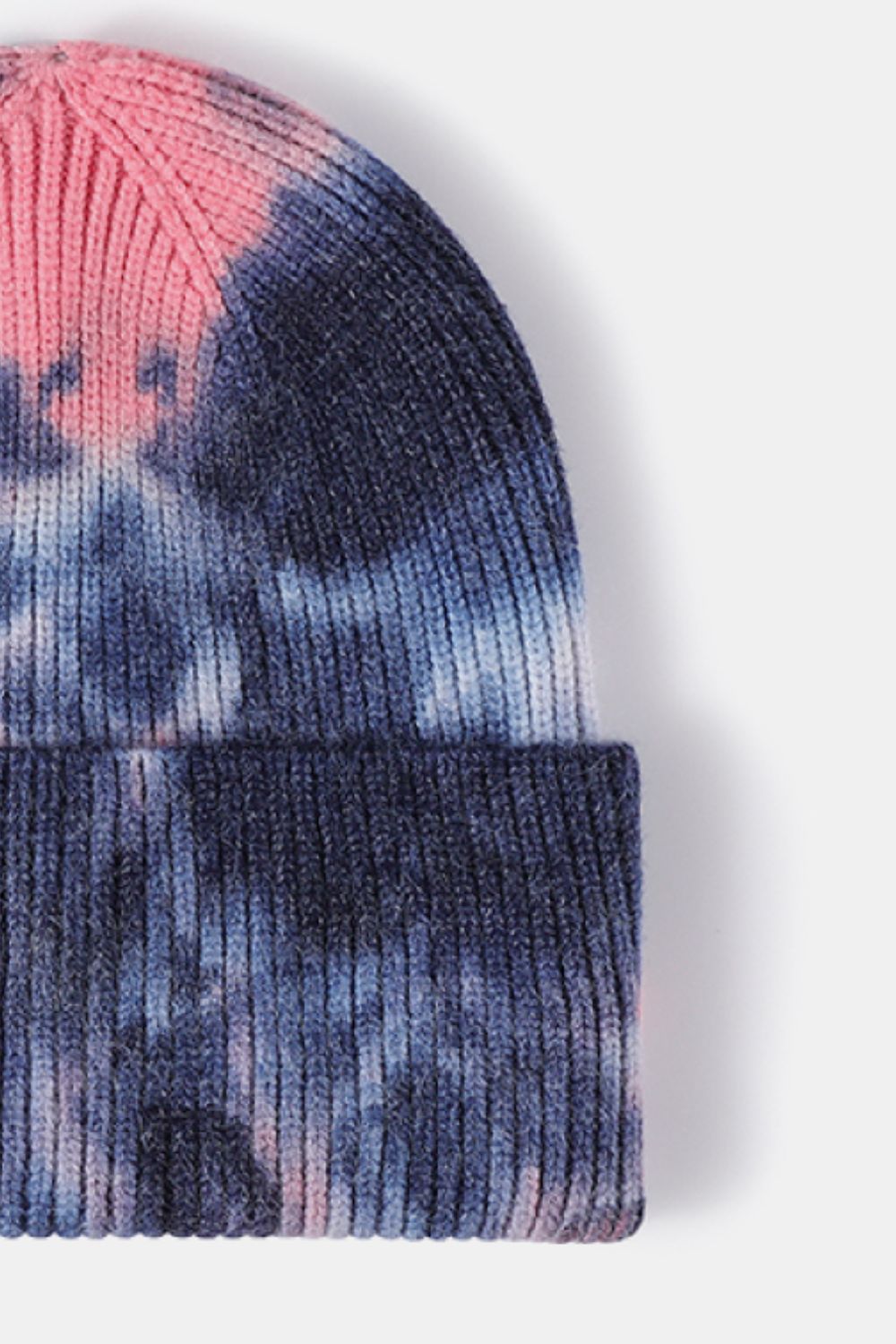 Stylish tie-dye cuffed rib-knit beanie hat in shades of pink and blue.