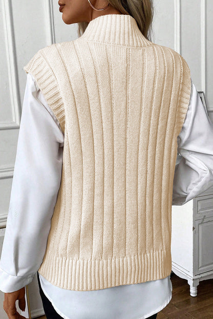 Cozy oatmeal cable knit high neck sweater vest with ribbed design, stylish layering piece for the modern fashionista.