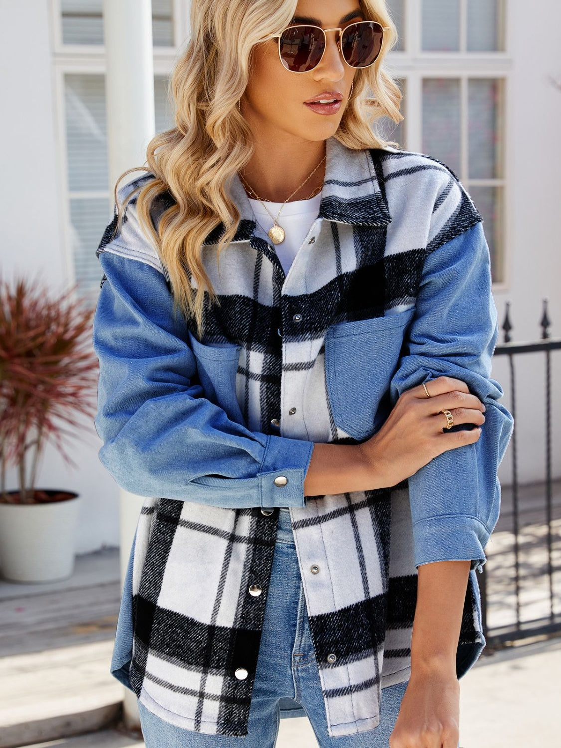 Stylish plaid and denim jacket with pockets, worn by a fashionable woman with sunglasses