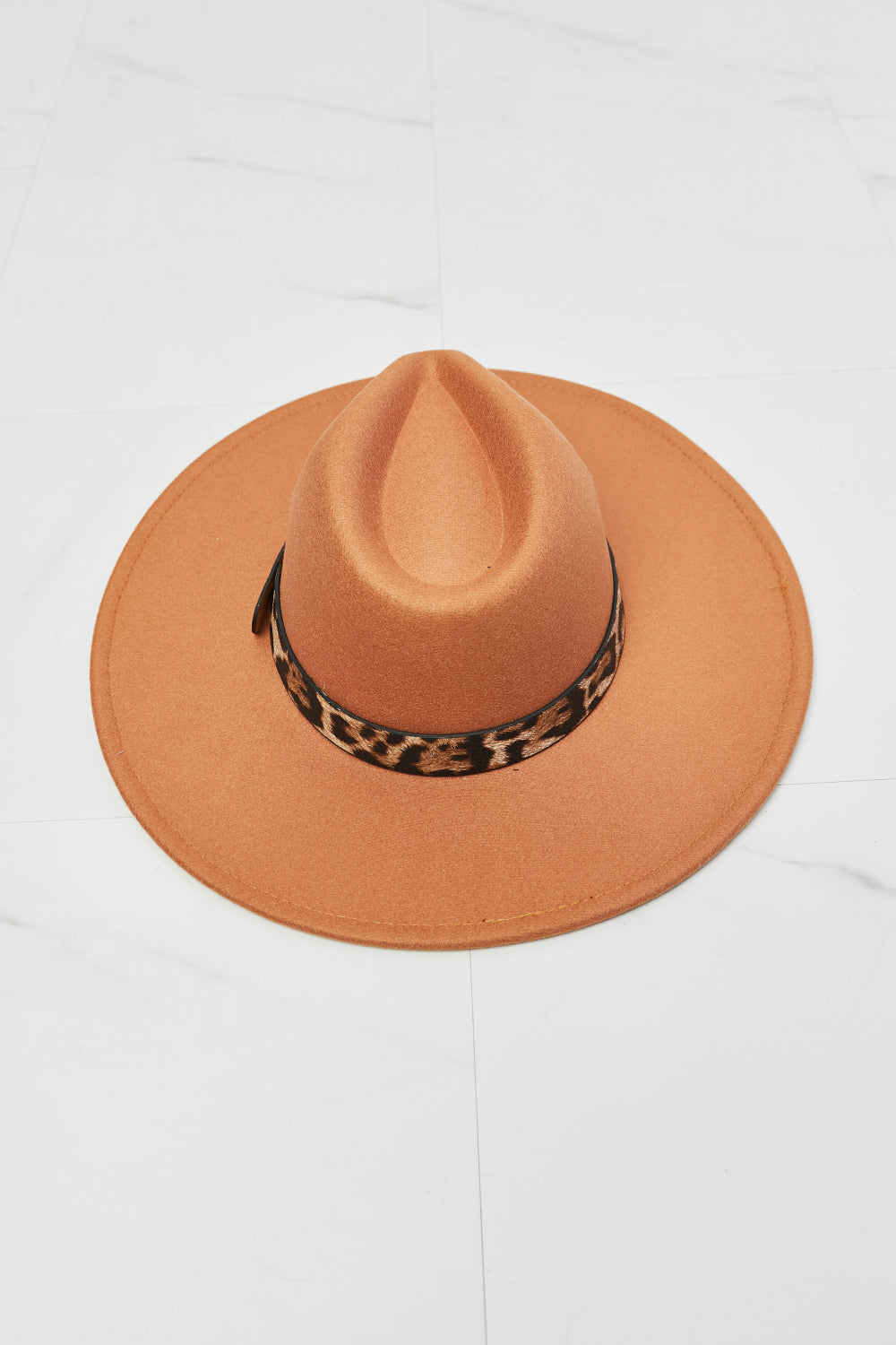 Fashion-forward orange fedora hat with animal print band, perfect for a day out in the wild.