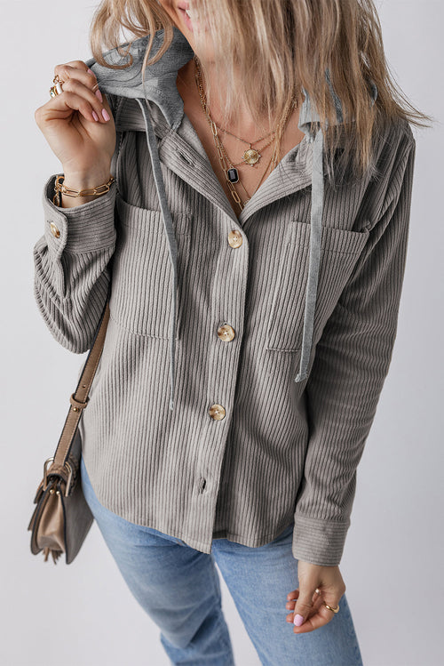 Casual grey corduroy shacket with hooded drawstrings and pockets, worn by a young woman with long blonde hair.