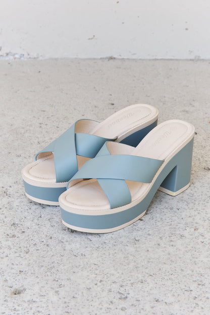 Elegant platform sandals in a soft misty blue hue. Featuring a contrasting strap design and a chunky high-heeled sole for a stylish, comfortable look. These versatile slides are perfect for pairing with casual or dressy ensembles.