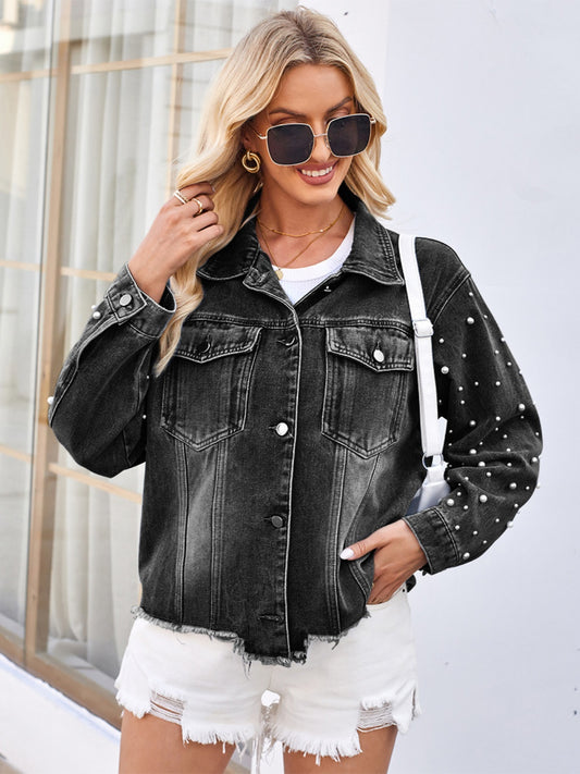 Chic pearl-trimmed denim jacket with raw hem, modeled against a modern urban setting