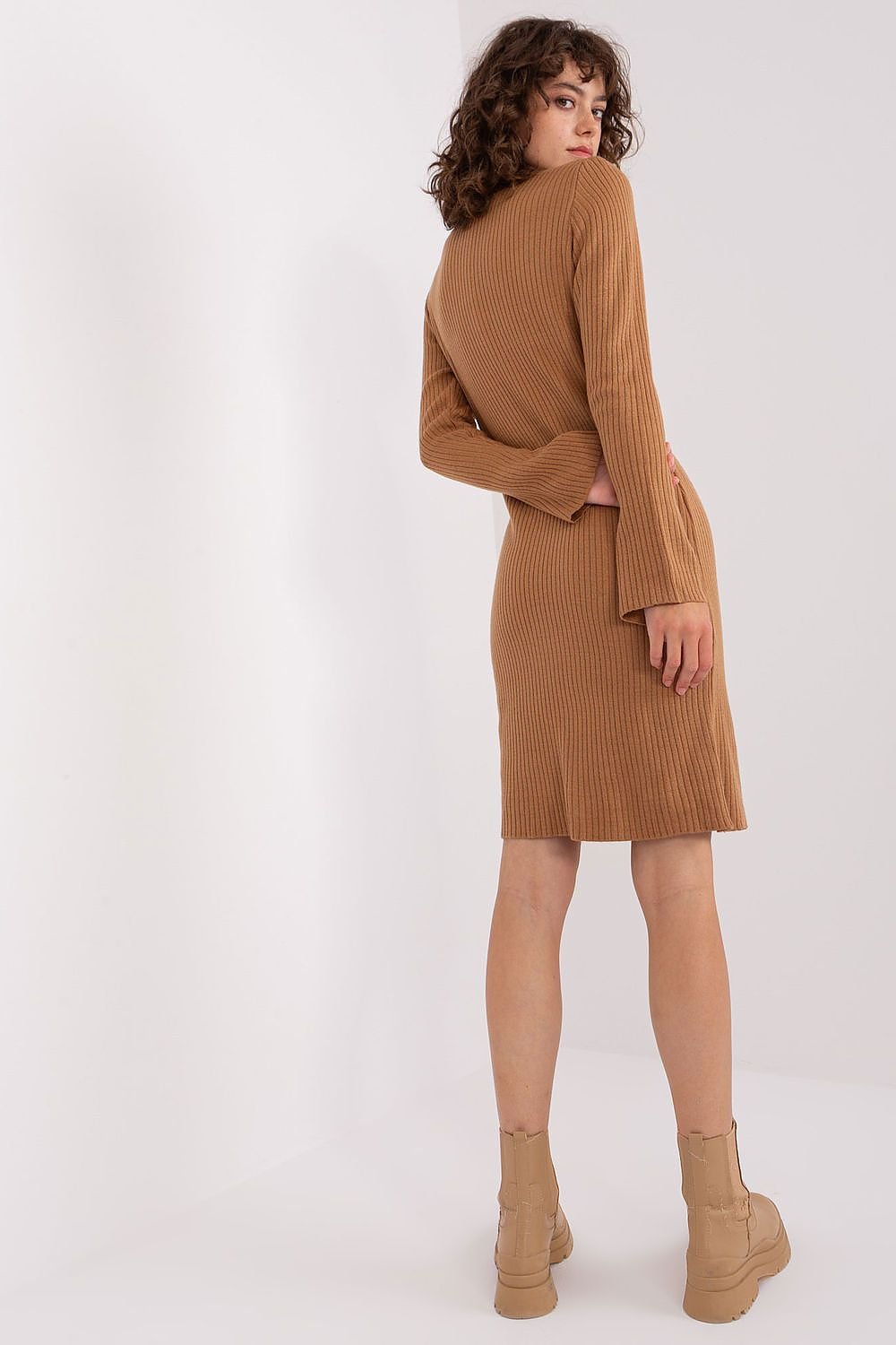 Cozy camel-colored ribbed knit dress with long sleeves, displaying a stylish and comfortable look for the modern woman.