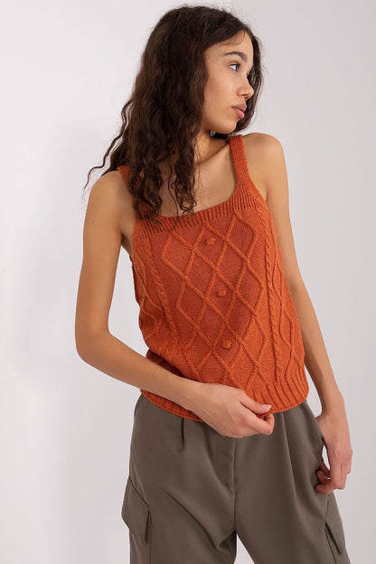 Elegant orange knit top with diamond-patterned design, sleeveless style, worn by young woman with curly dark hair.