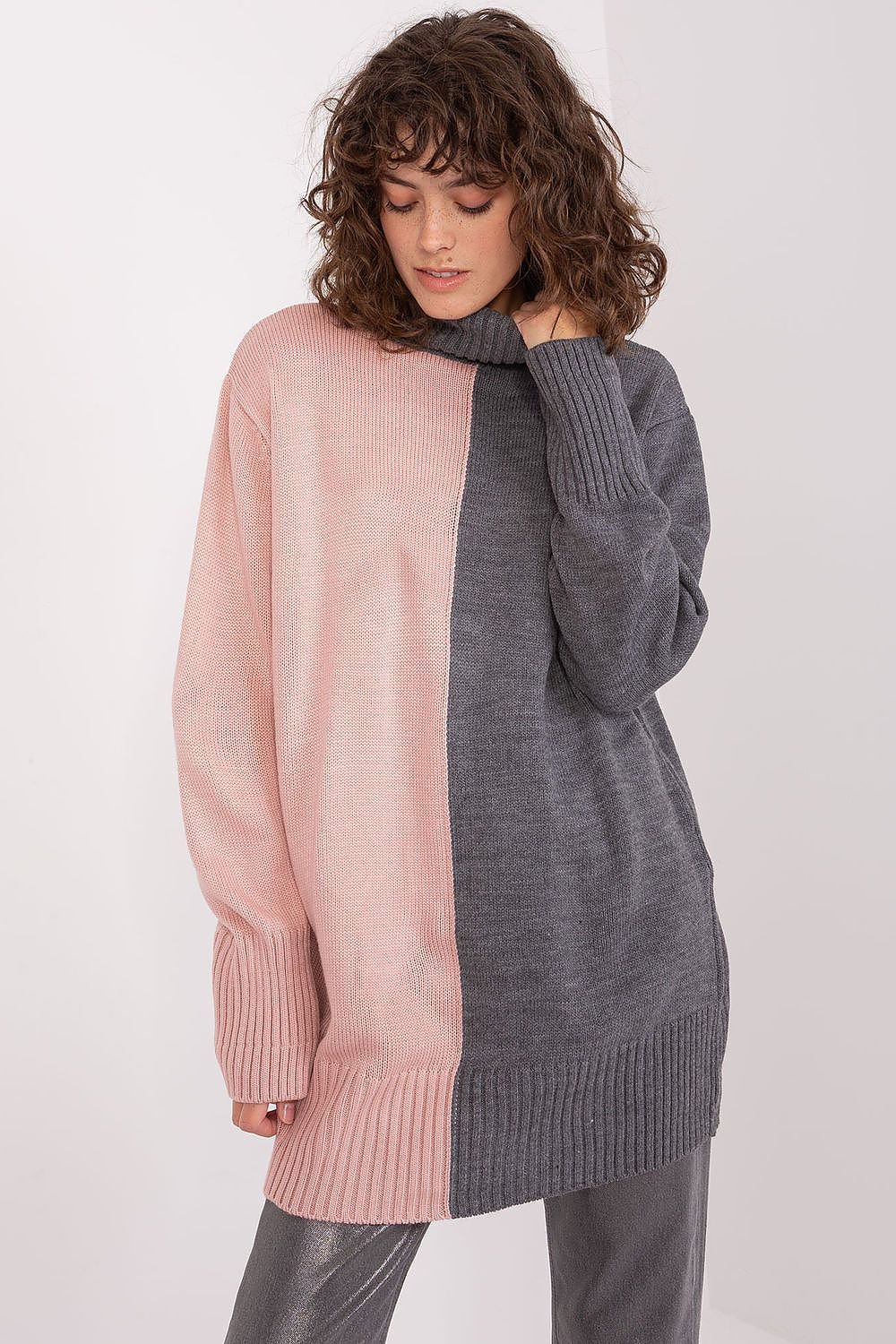 Stylish turtleneck sweater with contrasting colors and textures, featuring a cozy and fashionable design.