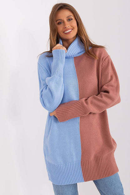 Colorful chunky knit turtleneck sweater for women in pastel pink and blue tones.