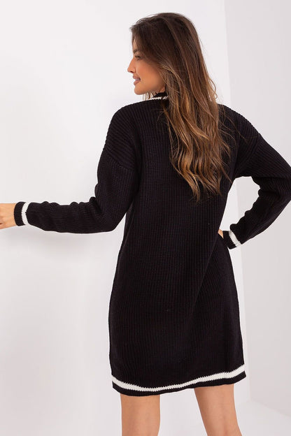 Chic black knit dress with contrasting trim design, featuring a stylish silhouette and showcased on a female model with long, wavy brunette hair.