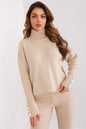 Elegant model wearing Turtleneck Badu, a soft knit sweater with button details on the sleeves, showcasing a stylish and cozy look.