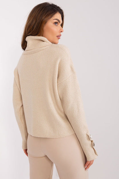 Cozy turtleneck sweater in beige from Badu, showing back view of woman wearing the stylish knit top.