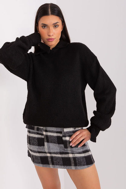 Cozy black wool jumper by Badu, featuring a high collar and billowing sleeves for a stylish and comfortable look.