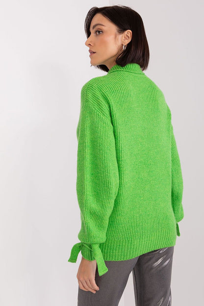 Vivid green knitted jumper with tie cuffs, showcased on a female model